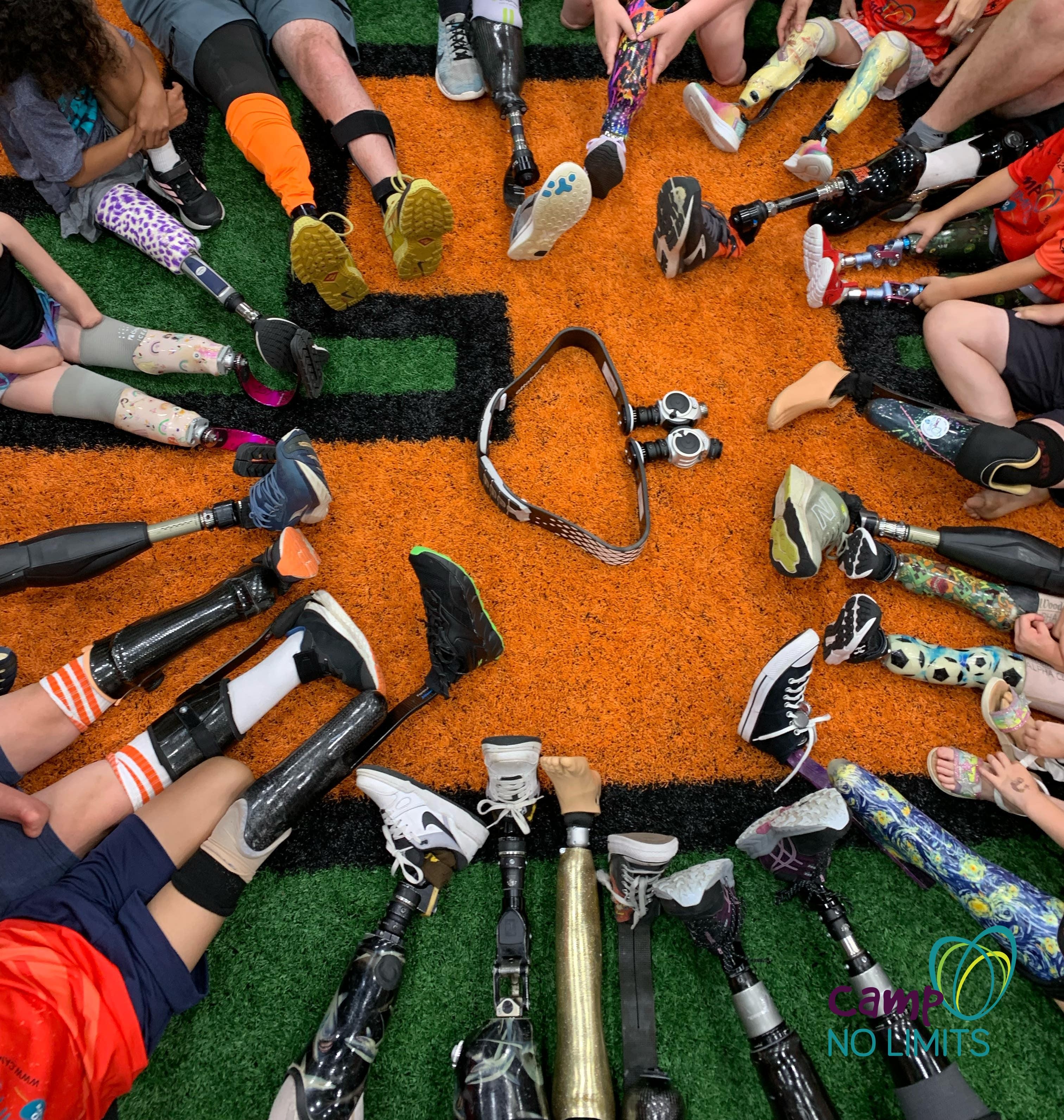 Children's prosthetic legs lined up at Camp No Limits, an inclusive camp for kids with limb differences