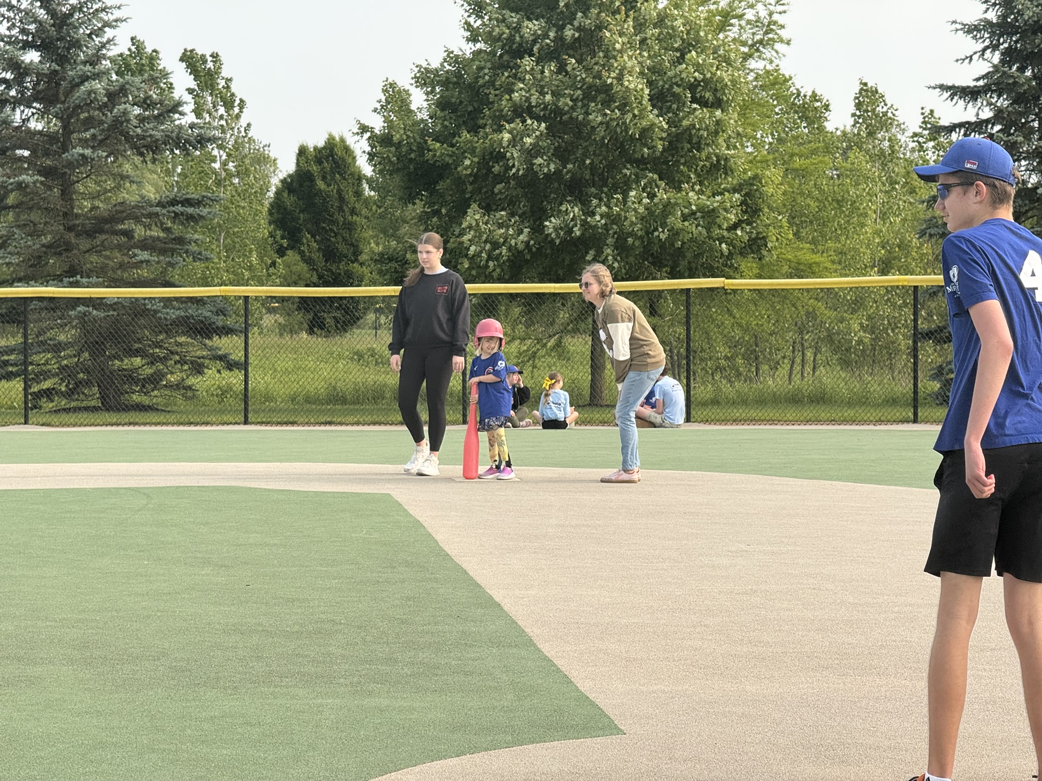 Gwen running bases with The Miracle League of Central Ohio on an accessible baseball field