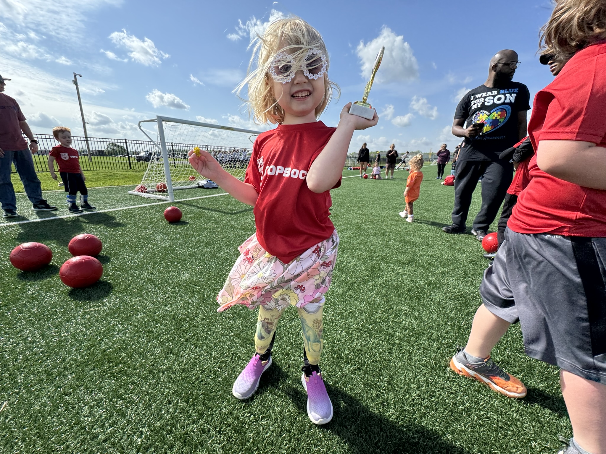 Gwen holding her trophy on the last day of TOPSoccer in Prairie Township, Ohio